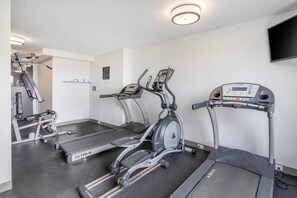 A gym with treadmills, an elliptical, and a weight machine.