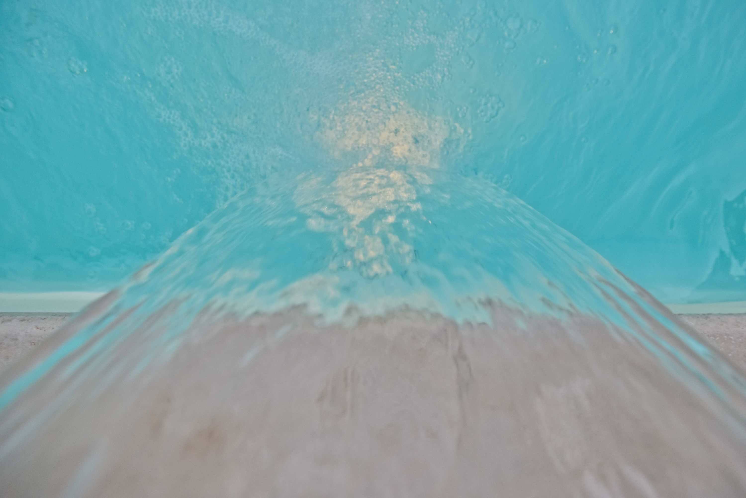 outdoor pool, a waterfall pool, pool umbrellas, pool loungers