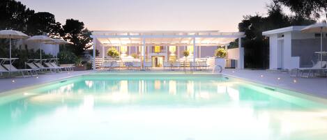 Outdoor pool, a waterfall pool, pool umbrellas, pool loungers