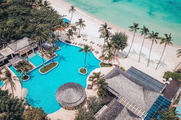 An aerial view of a resort with a large swimming pool, beach, and palm trees. - Melati Beach Resort & Spa (Koh Samui)