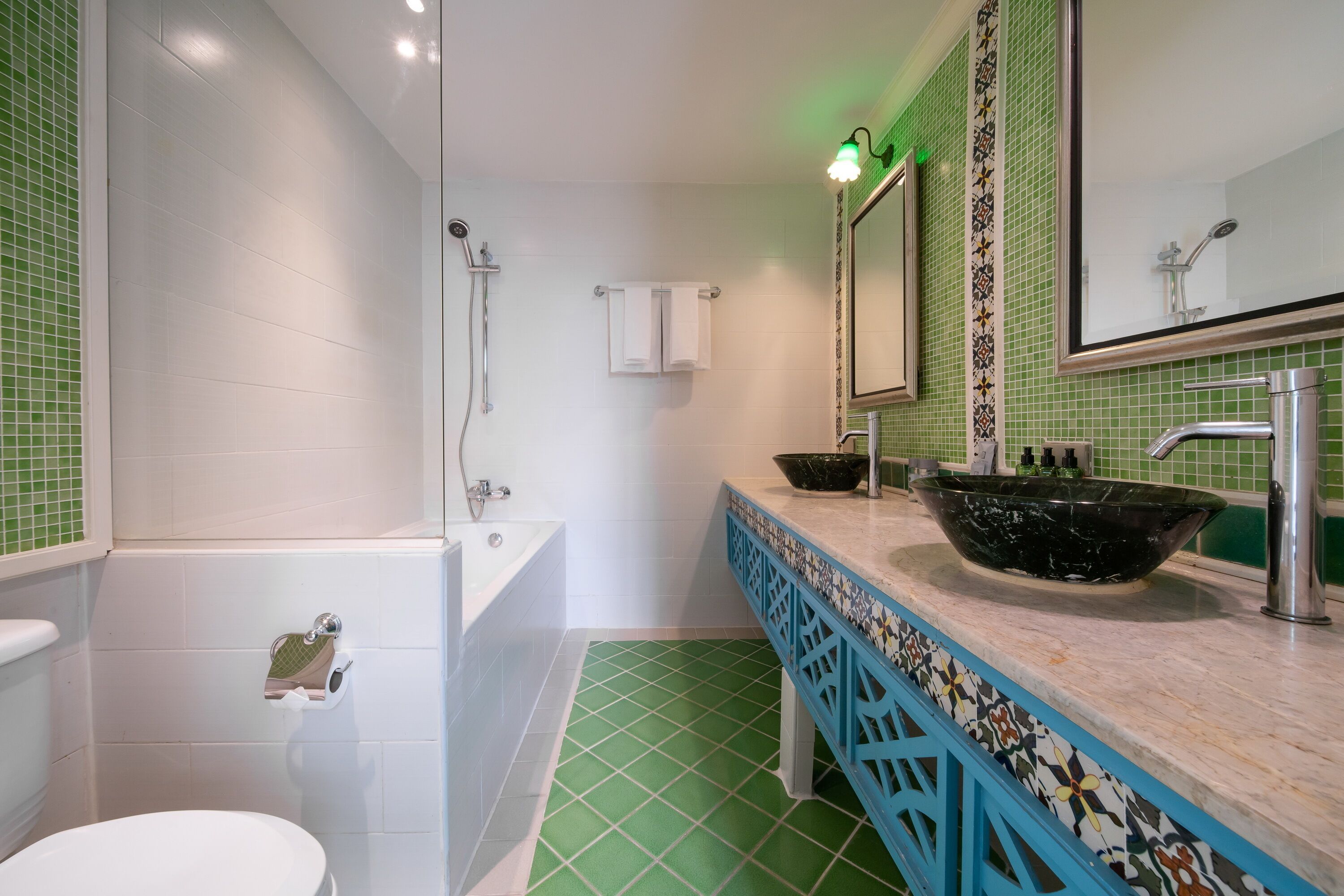 A bathroom with a bathtub, a sink with a large bowl, and a mirror.
