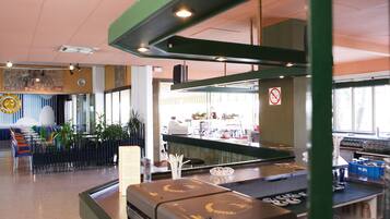 A restaurant interior with a bar area, seating, and a counter.
