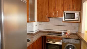 Fridge, microwave, coffee/tea maker, cookware/dishes/utensils