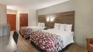 A hotel room with two beds, a desk, and a chair. - Red Roof Inn Panama City (Panama City)