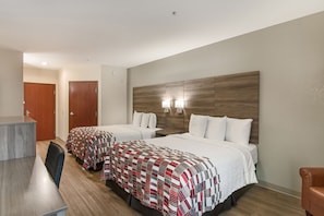 A hotel room with two beds, a desk, and a chair. - Red Roof Inn Panama City (Panama City)