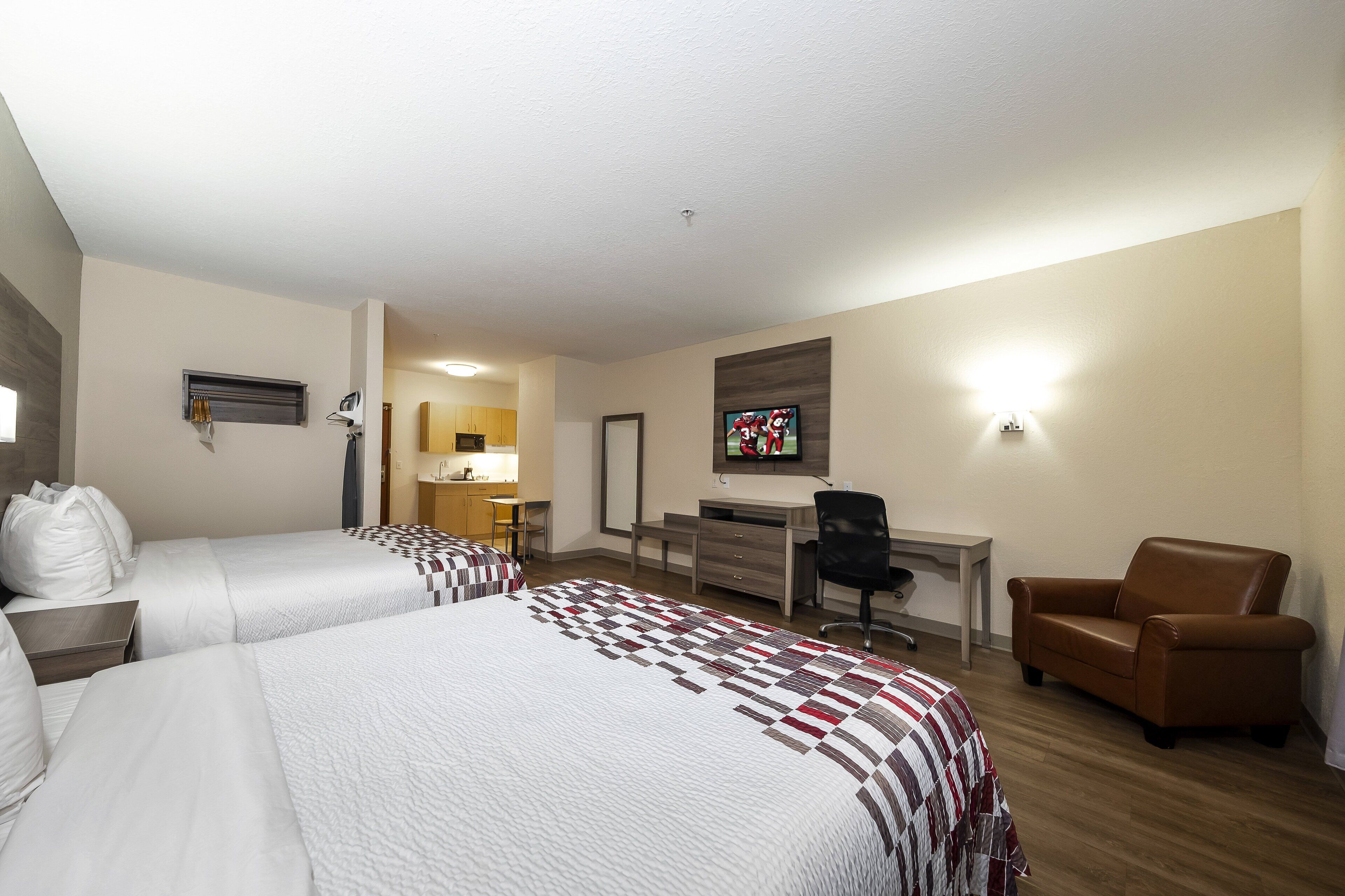 deluxe room, 2 queen beds, non smoking, kitchenette | blackout curtains, iron/ironing board, free cots/infant beds