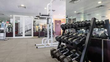 A gym with various exercise equipment, including dumbbells and weight machines.