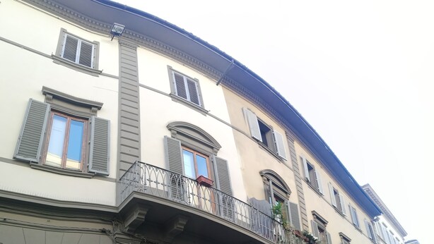 A multi-story building with classic architecture, featuring arched windows and balconies with wrought iron railings. - La Residenza Il Maggio B&B (Florence)