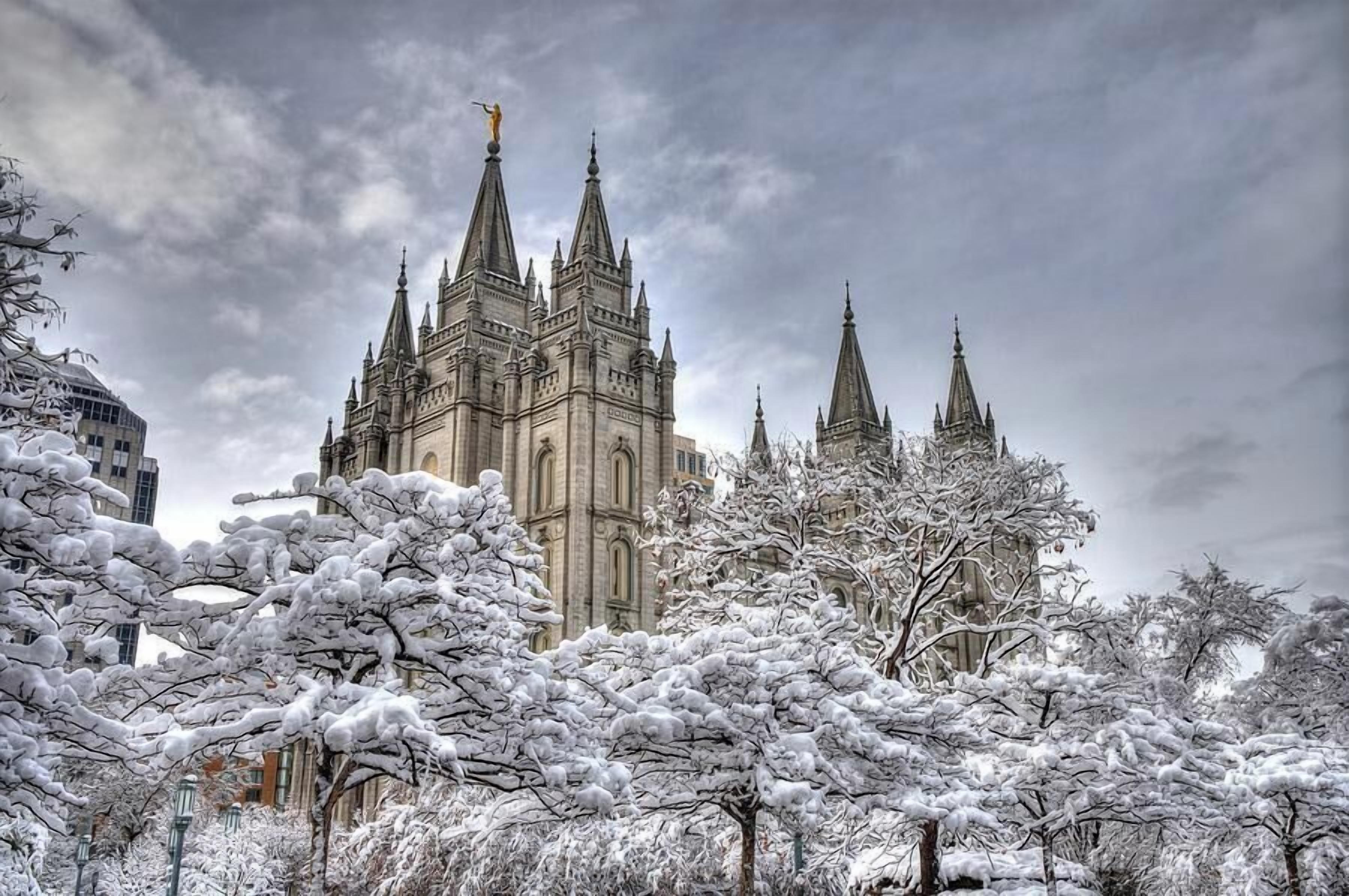A historic building with multiple spires and a statue on top.