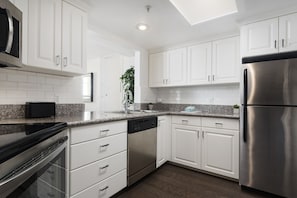 Deluxe Condo, 1 Bedroom | Private kitchen | Dishwasher, coffee/tea maker, cookware/dishes/utensils