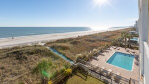 A pool area with a view of the beach and ocean. - Windy Shores II (North Myrtle Beach)