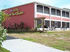 A building with a red facade and a sign that reads "Beach Inn & Suites."