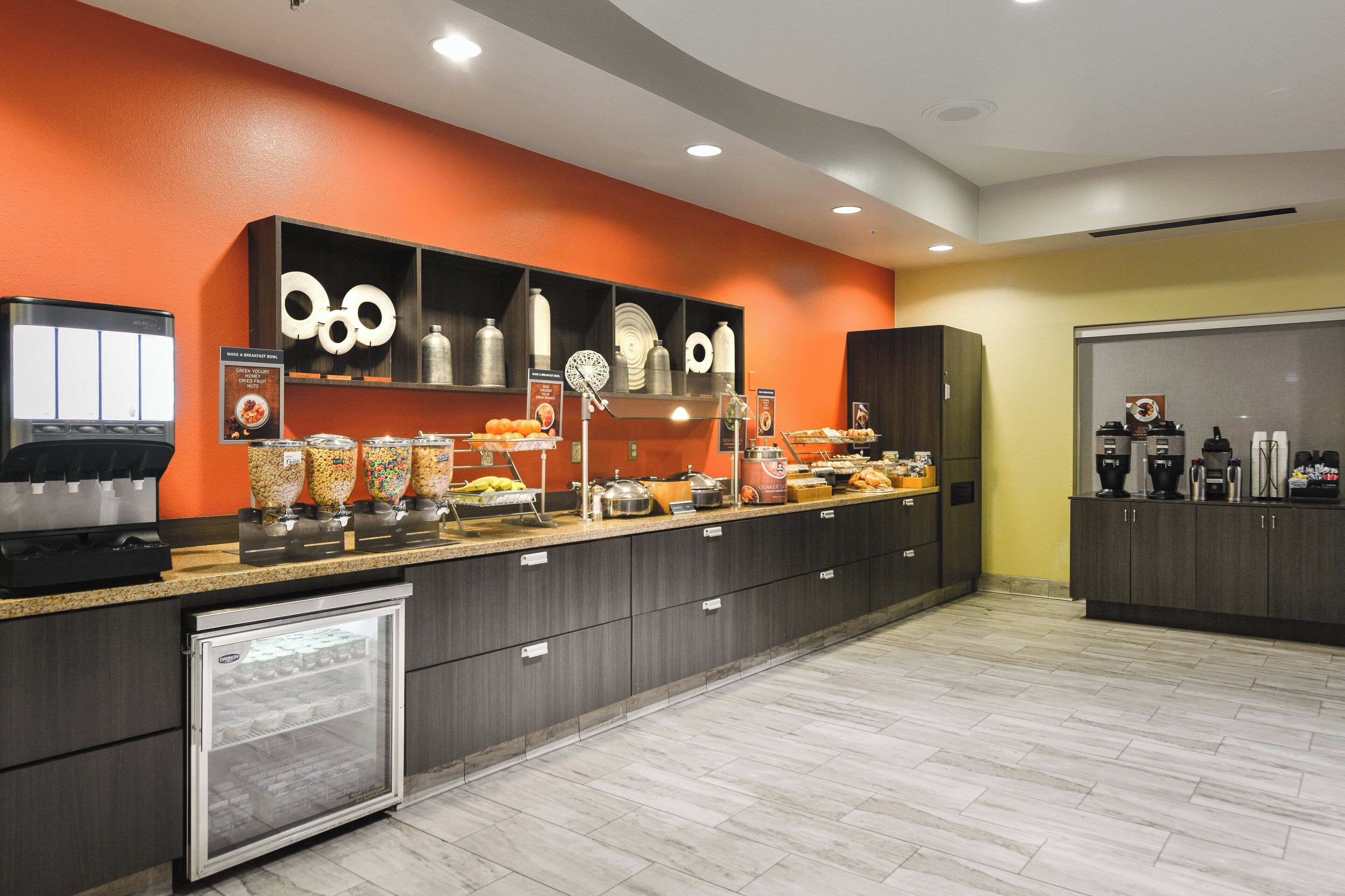 A buffet area with a variety of food items and a coffee station.