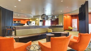 A modern lobby with a reception desk, seating area, and a TV mounted on the wall. - SpringHill Suites Shreveport-Bossier City/Louisiana Downs (Bossier City)