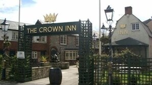 A traditional inn with a sign reading "The Crown Inn" and a crown symbol above the entrance. - The Crown Inn (Swindon)