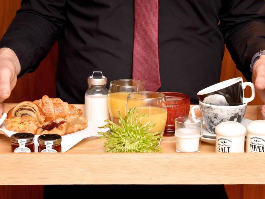 A tray with food items, drinks, and condiments.