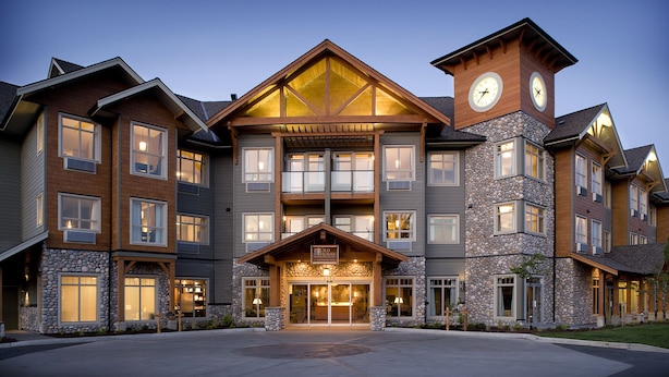A multi-story hotel with a stone facade, large windows, and a prominent clock tower. - Old House Hotel  (Courtenay)