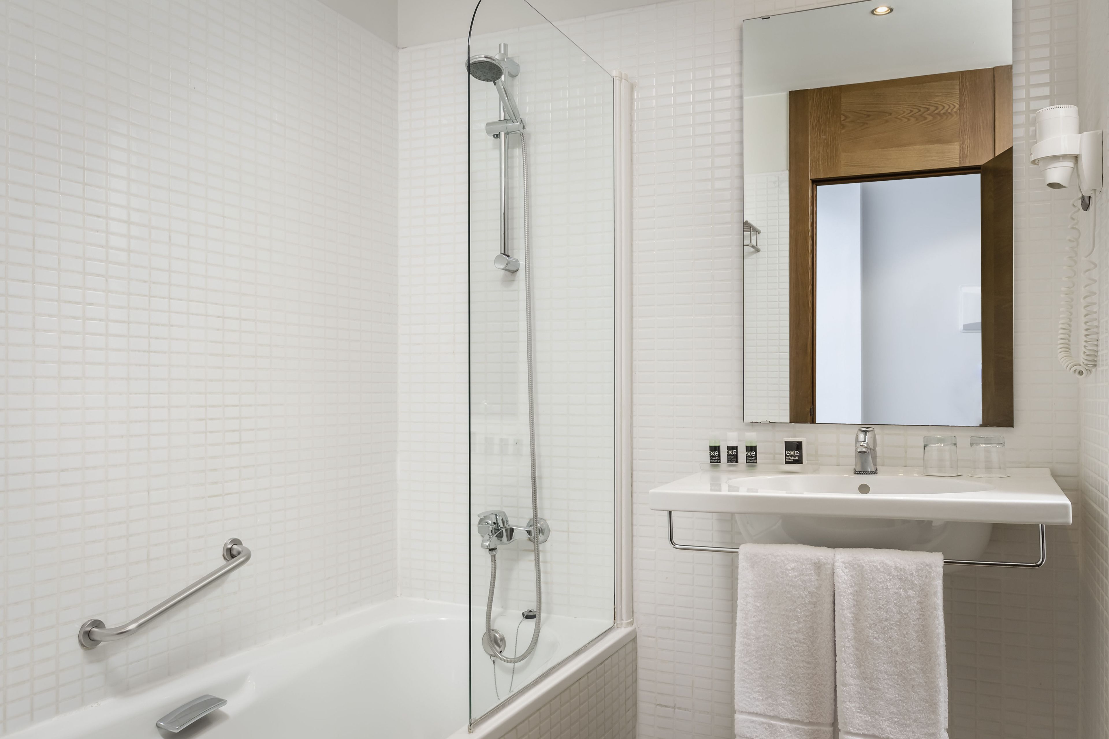 bathtub, eco-friendly toiletries, hair dryer, towels