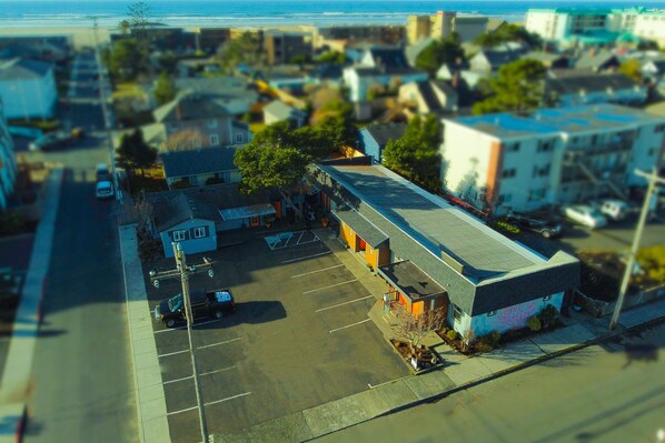 Commercial area with a mix of residential and commercial properties, featuring a two-story building and a one-story building.