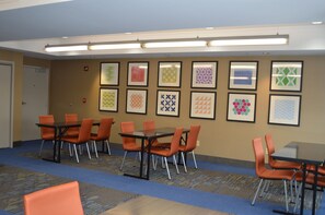 A conference room with tables and chairs, a patterned carpet, and framed artwork on the walls. - Holiday Inn Express Hotel & Suites Vestal by IHG (Vestal)