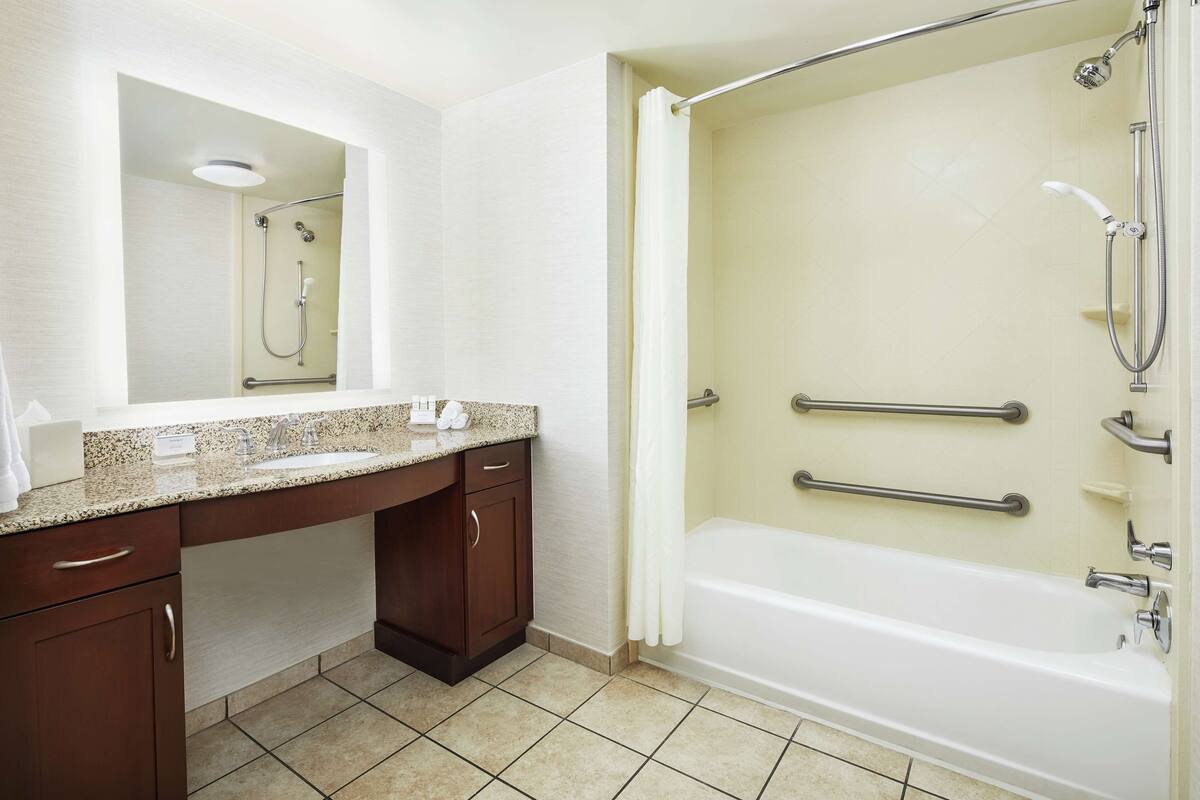 suite, 1 king bed, accessible, bathtub | bathroom | combined shower/bathtub, deep-soaking bathtub, hair dryer, towels