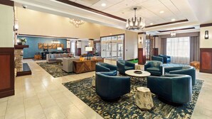 A spacious lobby with a reception desk, seating area with sofas, and a chandelier. - DoubleTree by Hilton Front Royal Blue Ridge Shadows (Front Royal)