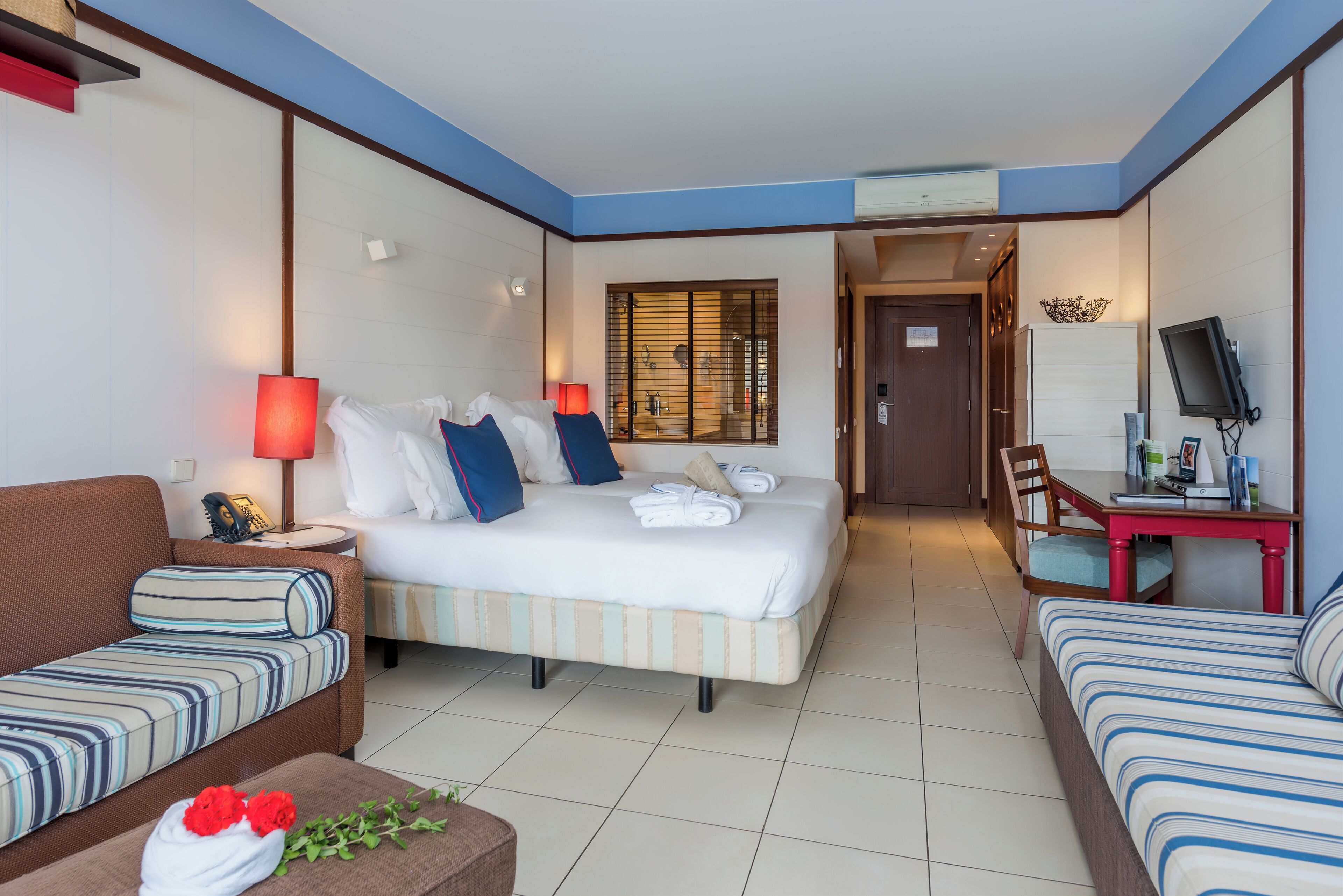 family room | minibar, in-room safe, desk, blackout curtains