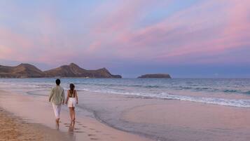 On the beach, sun-loungers, beach umbrellas, beach bar