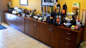 A breakfast bar with coffee machines, cereal, and condiments.