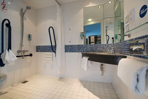 A modern bathroom with a shower, a sink, and a mirror.
