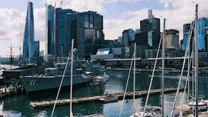 A marina with boats and a large ship docked, surrounded by modern high-rise buildings. - Metro Aspire Hotel, Sydney (Ultimo)