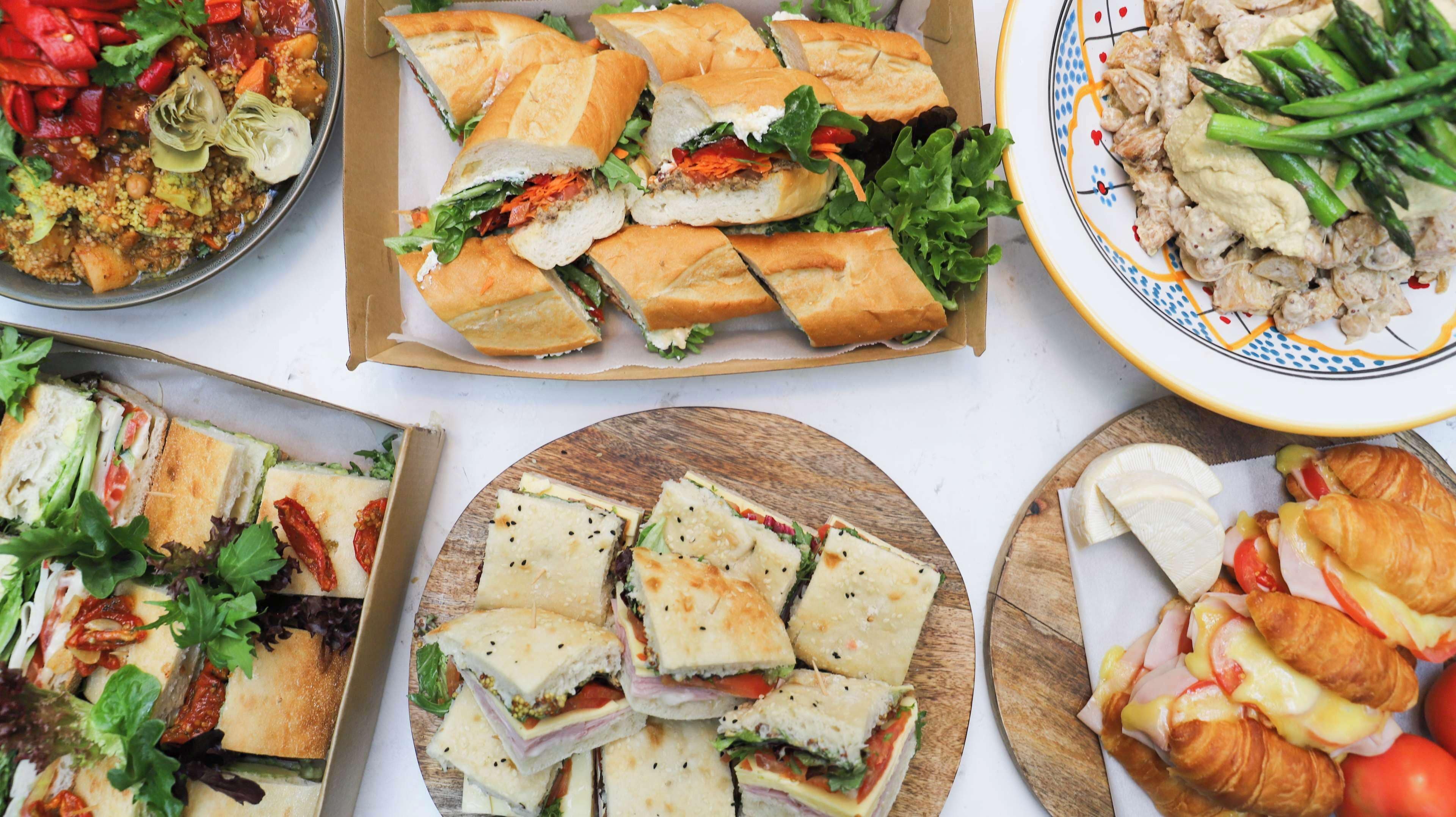 A variety of sandwiches and pastries on a table.