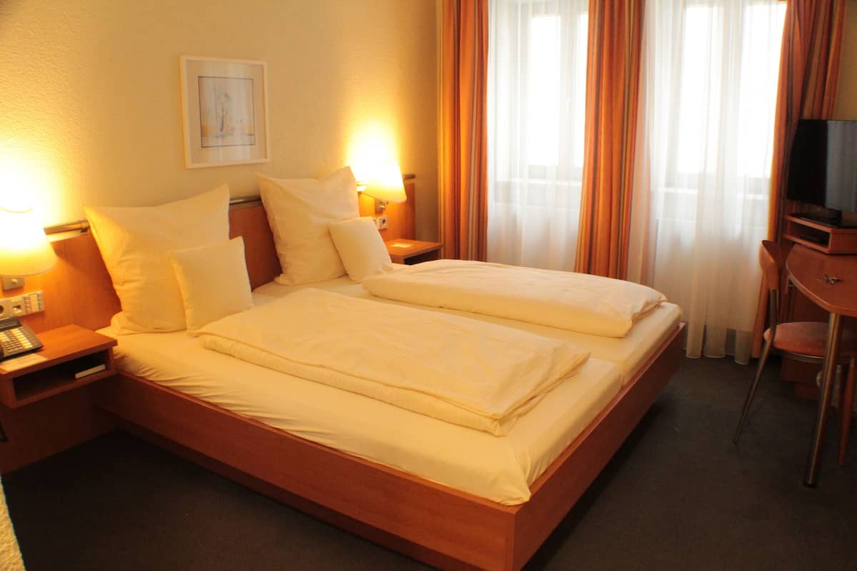 Ropa de cama de alta calidad y caja de seguridad en la habitación