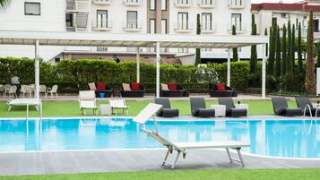 Seasonal outdoor pool, open 9:30 AM to 6:00 PM, pool umbrellas