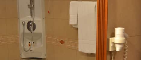 Un baño con lavamanos, espejo y ducha.