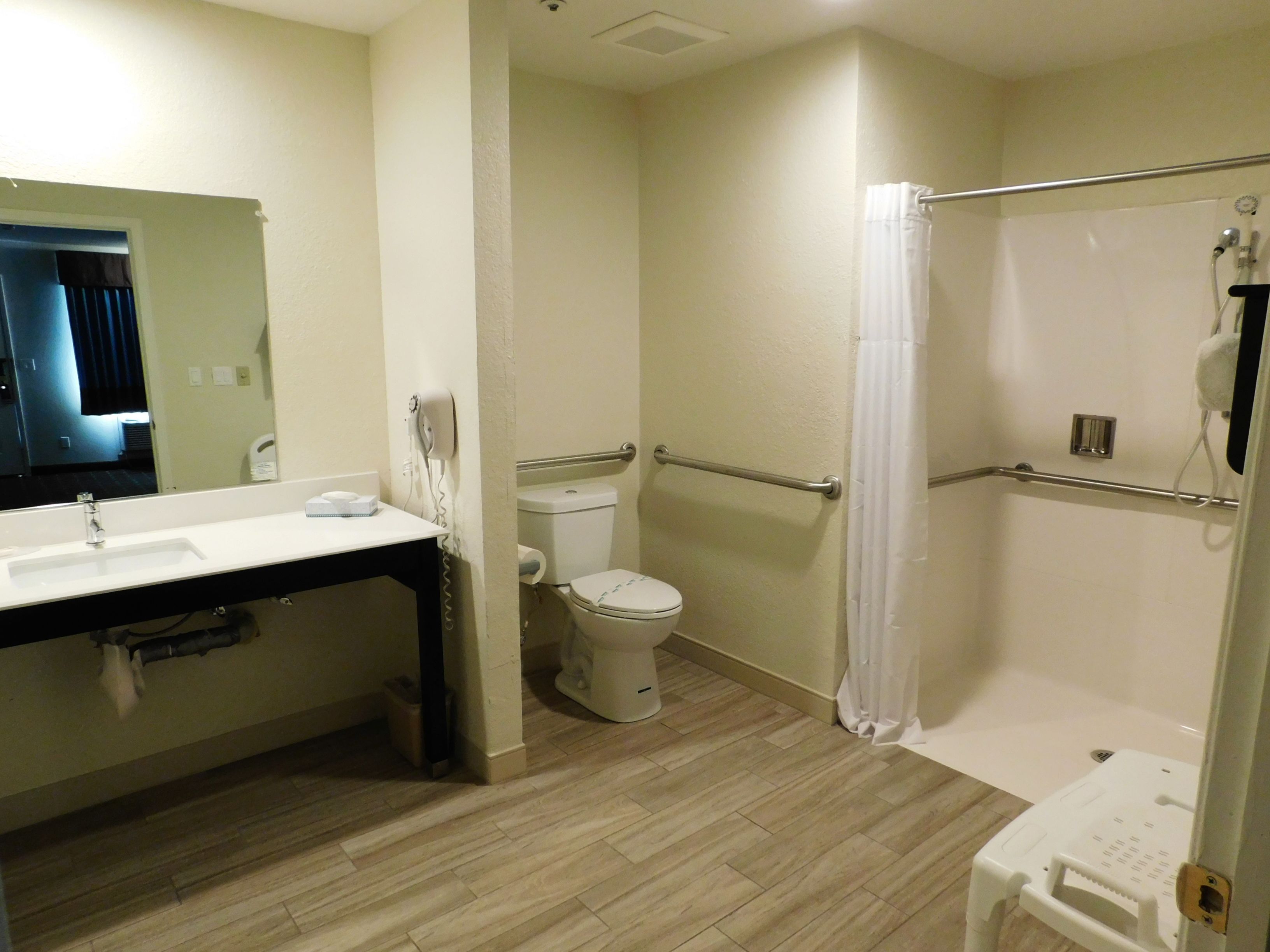 A bathroom with a sink, toilet, and shower.