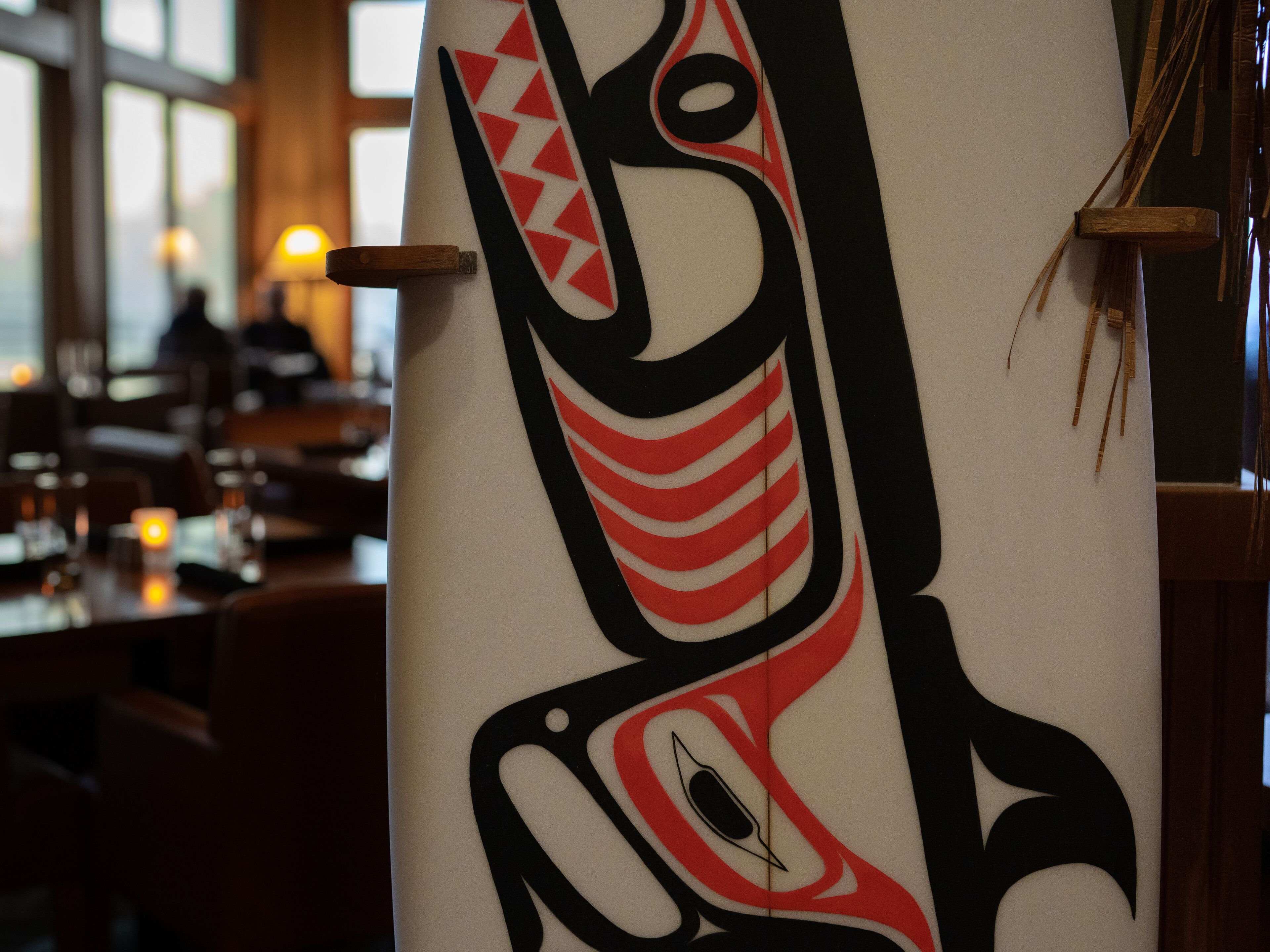 A close-up of a totem pole with geometric patterns.