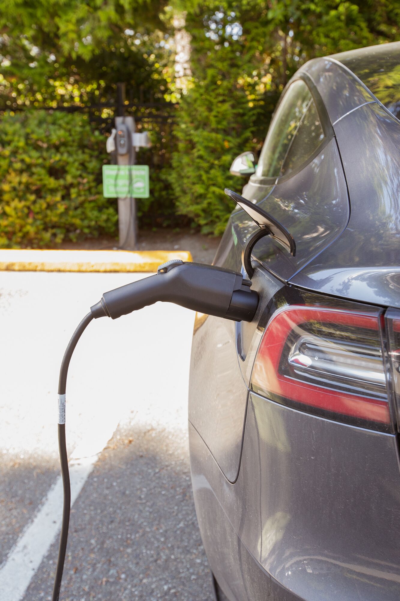 A car connected to an electric charging station.