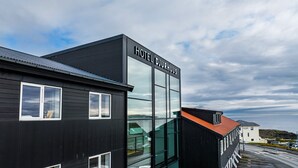 A modern hotel building with a prominent sign reading "HOTEL DJURHUUS". - Hotel Djurhuus (Tórshavn)