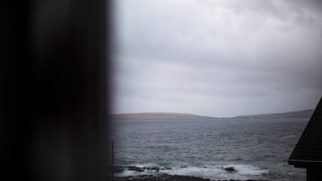 A view of a rocky shoreline with waves crashing onto the rocks.