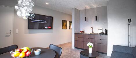 A modern kitchen with a dining area.