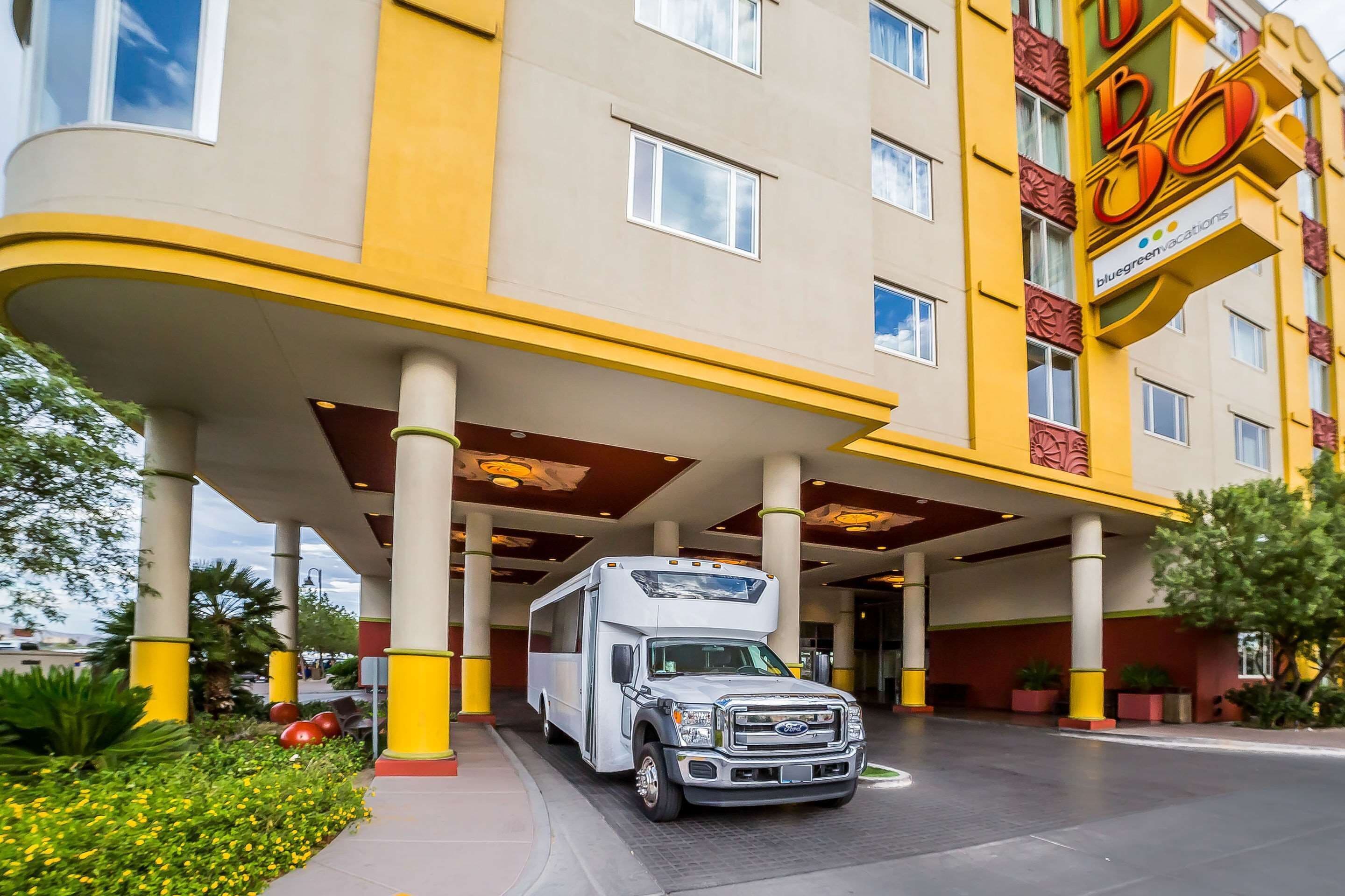 A hotel with a large RV parking area and a building with yellow and red accents.