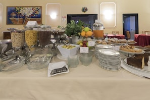 A buffet with various food items and beverages, including fruits, cereals, and desserts. - Villa Del Cardinale (Norma)
