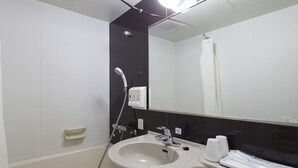 A bathroom with a white sink, a mirror, a shower, and a towel rack.