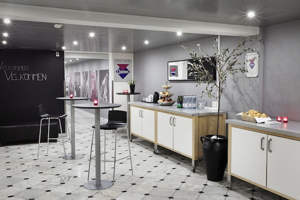 A modern kitchen area with a blackboard, a coffee machine, a sink, and a cabinet. - CABINN Scandinavia Hotel (Frederiksberg)