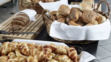 A variety of breads and pastries displayed on a table.