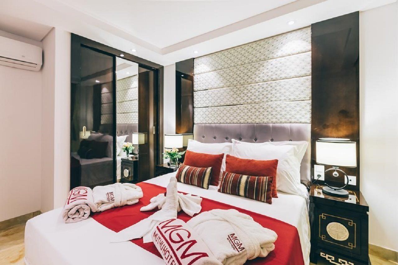 Desk, laptop workspace, iron/ironing board, bed sheets