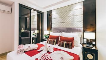 Desk, laptop workspace, iron/ironing board, bed sheets