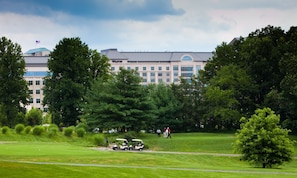 A golf course with a clubhouse in the background.