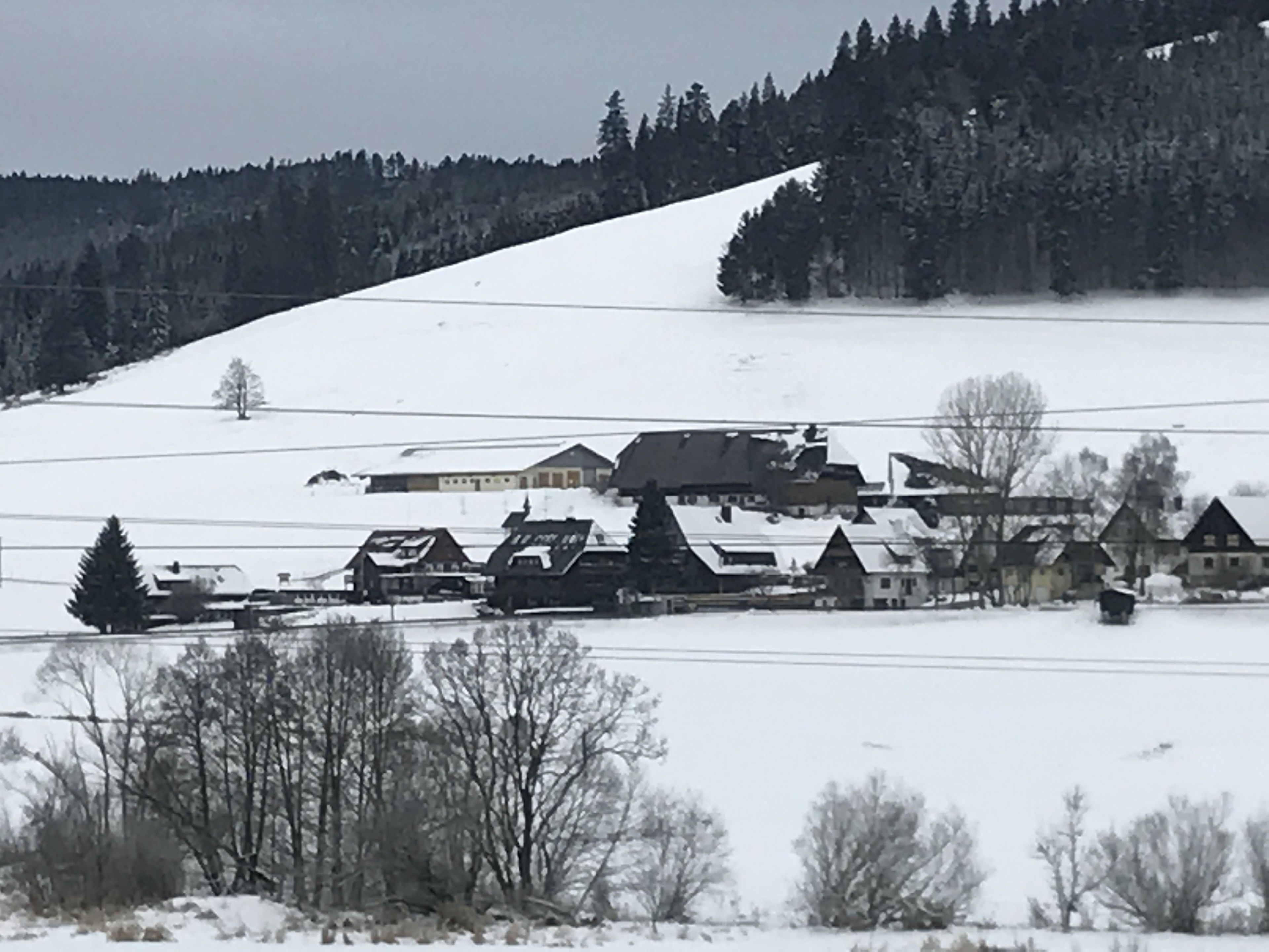 A snow-covered village with houses and a church.